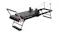 A full side view of the PROTRAIN Reformer Pilates Device with Headrest A full side view of the PROTRAIN Reformer Pilates Device with Headrest