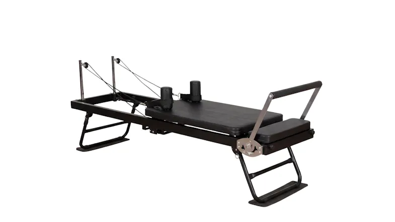 Side-angle view of a black folding Pilates reformer machine showcasing its frame, footbar, and attached straps Side-angle view of a black folding Pilates reformer machine showcasing its frame, footbar, and attached straps
