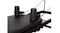 A close-up detail of two cylindrical padded shoulder rests and connected straps on a black Pilates reformer carriage A close-up detail of two cylindrical padded shoulder rests and connected straps on a black Pilates reformer carriage