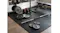 Threaded barbell shaft on a home gym floor surrounded by weight plates, dumbbells, and a bench Threaded barbell shaft on a home gym floor surrounded by weight plates, dumbbells, and a bench