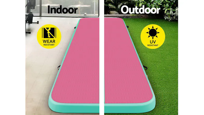 Pink and green TSB Living inflatable gymnastics mat displayed for indoor and outdoor use, with wear- and UV-resistance icons Pink and green TSB Living inflatable gymnastics mat displayed for indoor and outdoor use, with wear- and UV-resistance icons