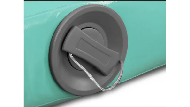 Close-up of the air track mat's air valve cap on the green side panel Close-up of the air track mat's air valve cap on the green side panel
