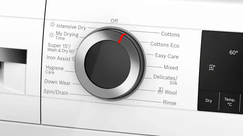 Detailed view of the control dial and digital display panel. Multiple wash and dry programmes are visible Detailed view of the control dial and digital display panel. Multiple wash and dry programmes are visible