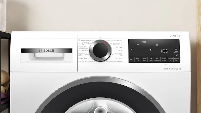 Front control panel of the washing machine and dryer combo, featuring a programme selector Front control panel of the washing machine and dryer combo, featuring a programme selector