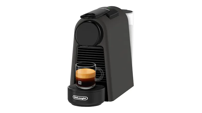 Angled view of the black Essenza Mini with a freshly brewed cup on the drip tray Angled view of the black Essenza Mini with a freshly brewed cup on the drip tray
