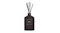 Dark glass bottle of Moss St. Vintage Leather & Cedarwood reed diffuser with five black reeds Dark glass bottle of Moss St. Vintage Leather & Cedarwood reed diffuser with five black reeds