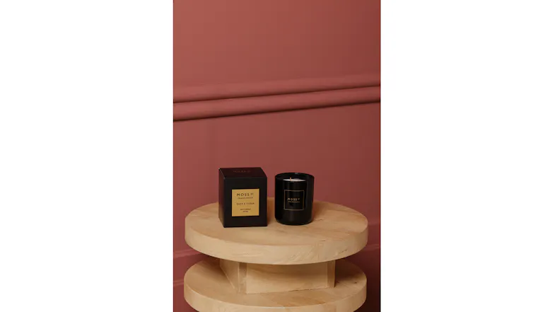 Modern interior featuring black candle and box on wooden stool Modern interior featuring black candle and box on wooden stool