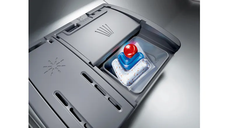 Close-up view showcasing detergent dispenser tray with cleaning tablet Close-up view showcasing detergent dispenser tray with cleaning tablet