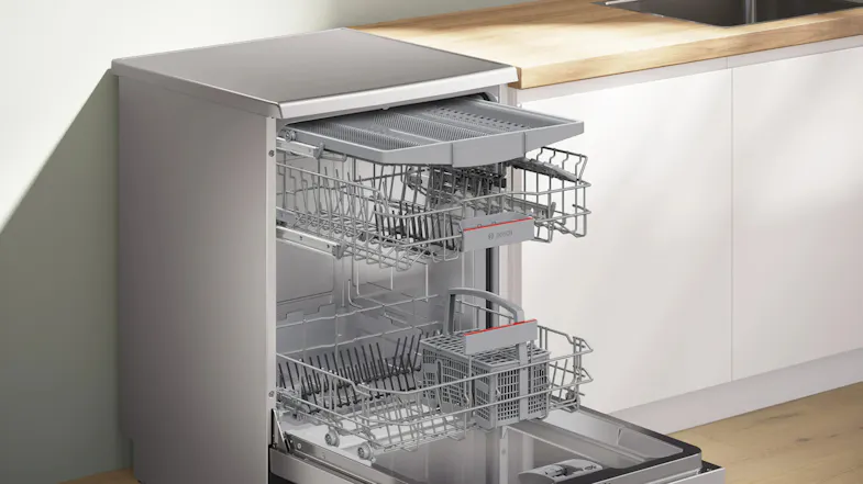 Perspective view showing open Bosch dishwasher door with extended wire racks Perspective view showing open Bosch dishwasher door with extended wire racks