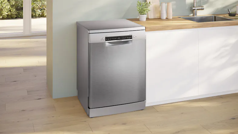 Freestanding view showcasing dishwasher placed in a bright kitchen space Freestanding view showcasing dishwasher placed in a bright kitchen space