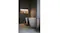 Modern bathroom with a freestanding white bathtub, dark stone tiles, and warm recessed shelf lighting Modern bathroom with a freestanding white bathtub, dark stone tiles, and warm recessed shelf lighting