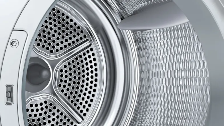 Macro view of the heat pump dryer showing the interior drum filter Macro view of the heat pump dryer showing the interior drum filter