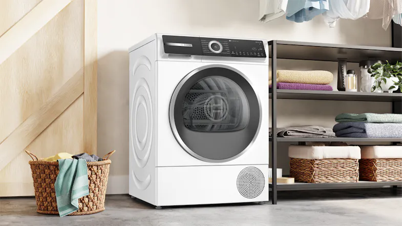 Modern laundry space featuring the dryer placed on tiled flooring Modern laundry space featuring the dryer placed on tiled flooring