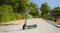 Outdoor view of a mint green electric scooter on a recreational trail lined with lush vegetation Outdoor view of a mint green electric scooter on a recreational trail lined with lush vegetation