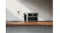 Anker SOLIX portable power station charging from a wall outlet on a wooden shelf Anker SOLIX portable power station charging from a wall outlet on a wooden shelf