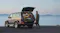 Person loading an Anker SOLIX portable power station into an SUV packed for travel or camping Person loading an Anker SOLIX portable power station into an SUV packed for travel or camping