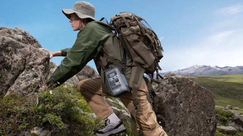 Backpacker climbing rocky terrain with a portable power station for reliable off-grid energy on the trail Backpacker climbing rocky terrain with a portable power station for reliable off-grid energy on the trail