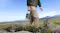 A person carrying a portable power station during outdoor hiking in a mountain landscape A person carrying a portable power station during outdoor hiking in a mountain landscape
