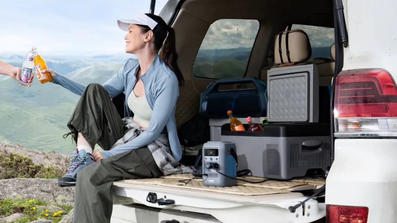 A 288Wh portable power station powering camping gear from an SUV tailgate with a cooler and outdoor refreshments A 288Wh portable power station powering camping gear from an SUV tailgate with a cooler and outdoor refreshments