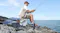 Solar-powered portable generator charging outdoor gear during a fishing trip on coastal rocks Solar-powered portable generator charging outdoor gear during a fishing trip on coastal rocks