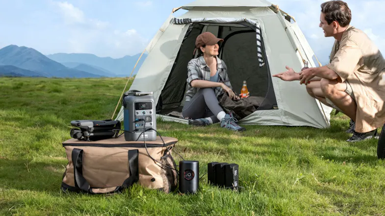 Off-grid power station charging camera gear and batteries at a remote tent campsite Off-grid power station charging camera gear and batteries at a remote tent campsite