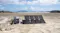288Wh portable power station charging via foldable solar panels on a sunny beach campsite 288Wh portable power station charging via foldable solar panels on a sunny beach campsite
