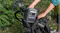 Cyclist loading a portable power station into a bicycle bag for reliable power on the go Cyclist loading a portable power station into a bicycle bag for reliable power on the go