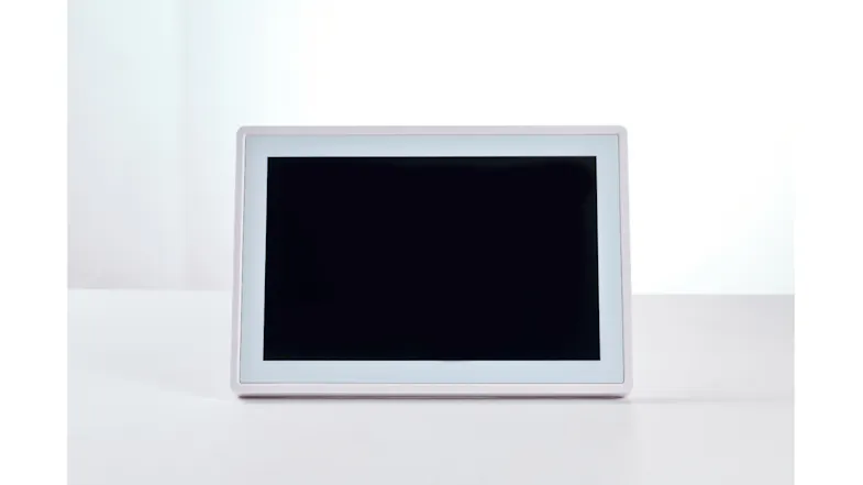 Front view featuring touchscreen calendar resting on white desk Front view featuring touchscreen calendar resting on white desk