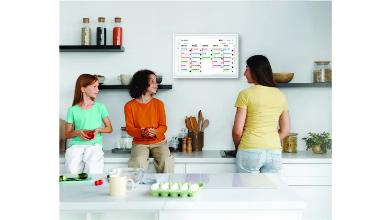 Bright kitchen featuring wall-mounted digital calendar with family Bright kitchen featuring wall-mounted digital calendar with family