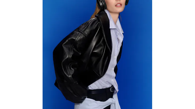 Person wearing a black leather jacket showcasing the Bose QuietComfort headphones Person wearing a black leather jacket showcasing the Bose QuietComfort headphones