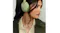 Close-up view of a woman wearing Bose headphones featuring a stylish look Close-up view of a woman wearing Bose headphones featuring a stylish look