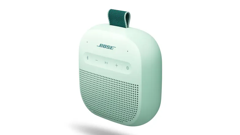 Angled front-side view of the Dewdrop Mint Bluetooth speaker highlighting the speaker grille and top controls Angled front-side view of the Dewdrop Mint Bluetooth speaker highlighting the speaker grille and top controls