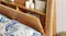 Side view of a wooden headboard highlighting hidden compartments Side view of a wooden headboard highlighting hidden compartments