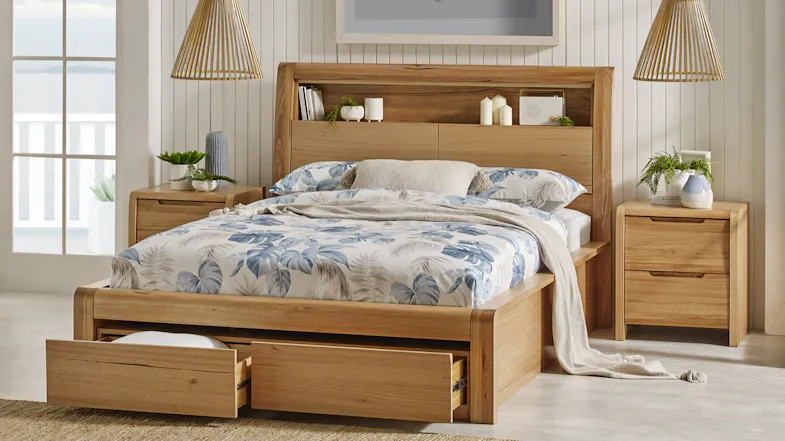 Front view of a king-sized bed frame with one bottom drawer opened Front view of a king-sized bed frame with one bottom drawer opened
