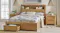 Front view of a wooden bed frame featuring built-in headboard shelves Front view of a wooden bed frame featuring built-in headboard shelves