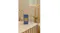 The room fragrance is displayed in a warmly-lit modern bathroom The room fragrance is displayed in a warmly-lit modern bathroom