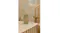 The room fragrance is displayed in a warmly-lit modern bathroom The room fragrance is displayed in a warmly-lit modern bathroom