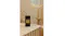 The room fragrance is displayed in a warmly-lit modern bathroom The room fragrance is displayed in a warmly-lit modern bathroom