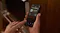 A view of a hand holding a smartphone while navigating the oven's compatible app A view of a hand holding a smartphone while navigating the oven's compatible app