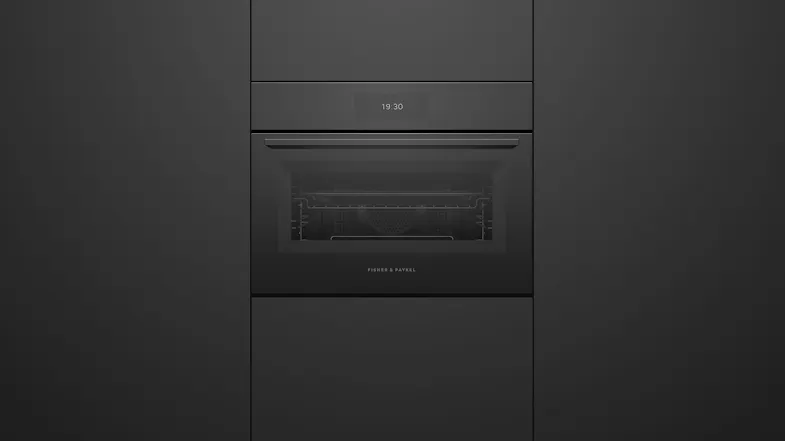 A front view of the oven integrated into a black wall A front view of the oven integrated into a black wall