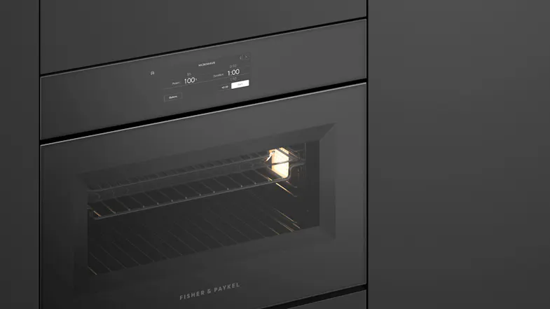 Angled close-up of Series 11 combi-microwave with interior light illuminated Angled close-up of Series 11 combi-microwave with interior light illuminated