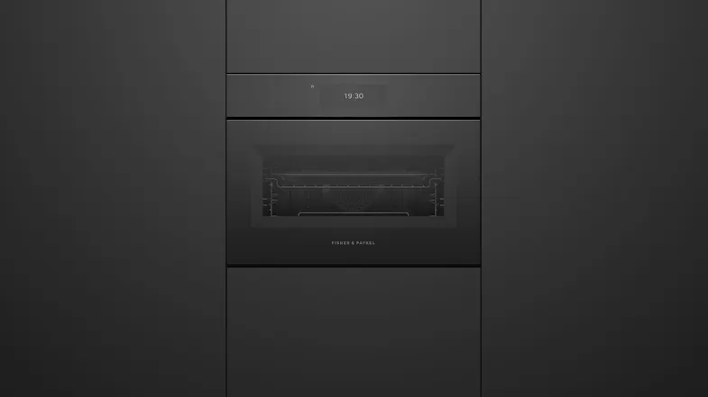 Straight-on view of Fisher & Paykel Series 11 combi-microwave seamlessly installed in black cabinetry Straight-on view of Fisher & Paykel Series 11 combi-microwave seamlessly installed in black cabinetry