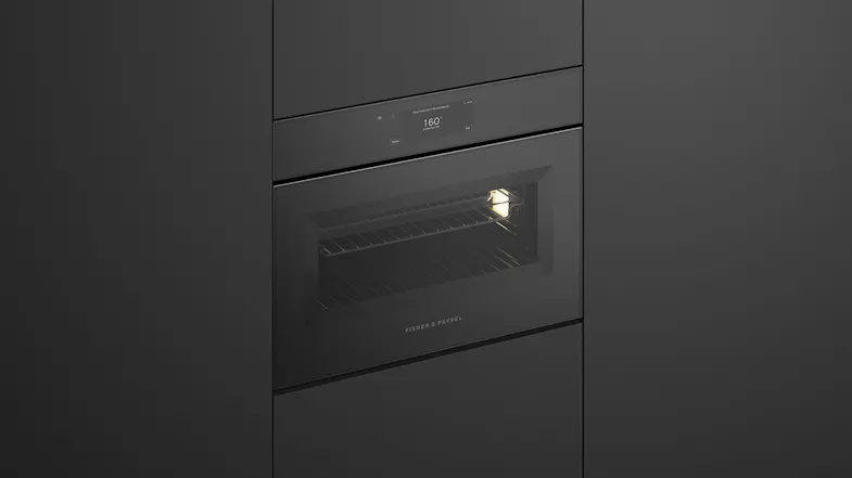 Angled view of Fisher & Paykel built-in microwave installed in modern seamless dark cabinetry Angled view of Fisher & Paykel built-in microwave installed in modern seamless dark cabinetry