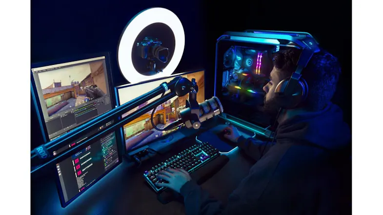 Gamer setup featuring a boom arm mounted near monitors and lights Gamer setup featuring a boom arm mounted near monitors and lights