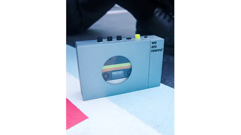 Blue portable cassette player positioned on a tabletop, emphasising its clean design Blue portable cassette player positioned on a tabletop, emphasising its clean design