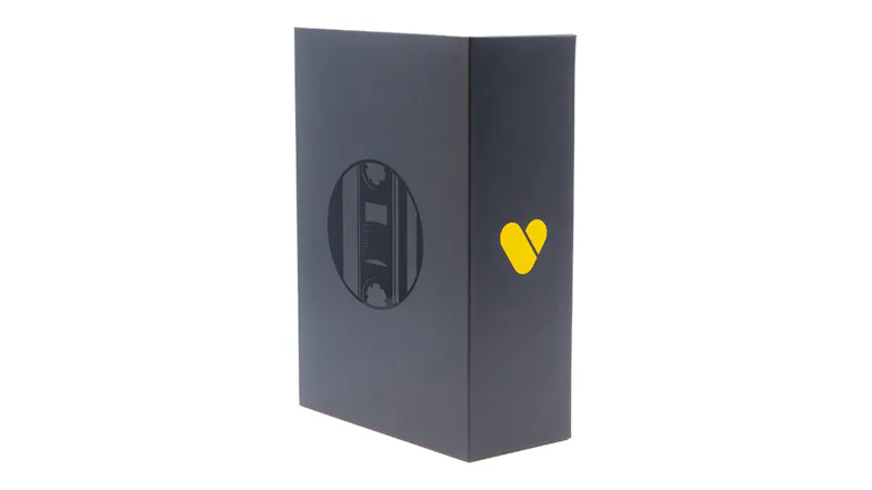 Side view of the product packaging with cassette window cutout and We Are Rewind branding on a black box Side view of the product packaging with cassette window cutout and We Are Rewind branding on a black box
