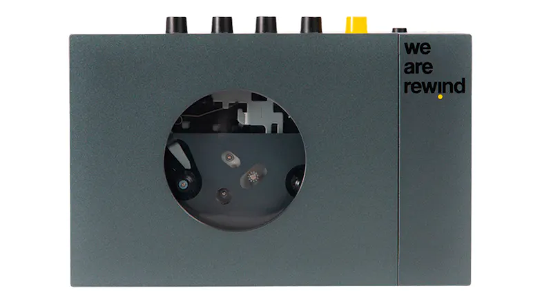 Front view of the We Are Rewind Keith Bluetooth cassette player in grey, featuring a circular cassette window Front view of the We Are Rewind Keith Bluetooth cassette player in grey, featuring a circular cassette window