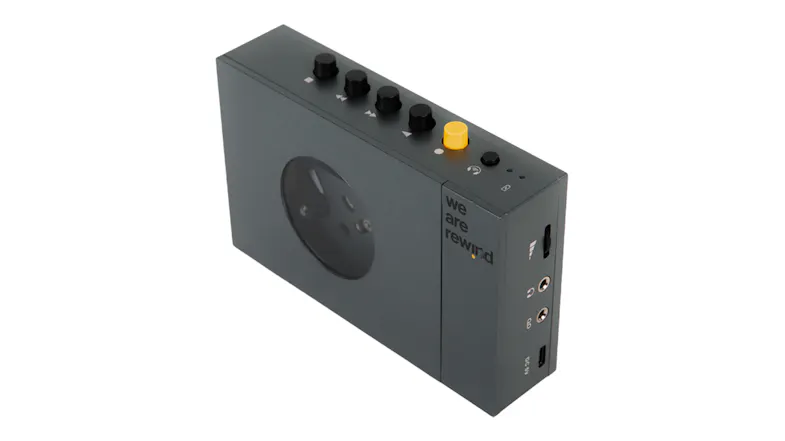 Angled front-side view of the grey cassette player showcasing the top control buttons and connectivity ports Angled front-side view of the grey cassette player showcasing the top control buttons and connectivity ports