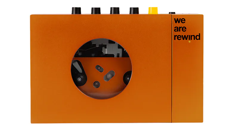 Front view of the We Are Rewind Serge Bluetooth cassette player in orange, featuring a retro design Front view of the We Are Rewind Serge Bluetooth cassette player in orange, featuring a retro design