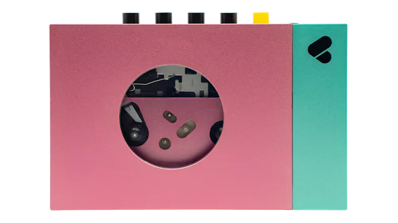 Front view of the We Are Rewind Edith Bluetooth cassette player featuring a pink body and green accent panel Front view of the We Are Rewind Edith Bluetooth cassette player featuring a pink body and green accent panel
